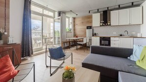 A modern apartment with a balcony, a dining area, a kitchen, and a living room. - House in Saint-Pabu near Stunning Beaches (Warszawa 2)