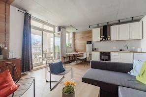 A modern apartment with a balcony, a dining area, a kitchen, and a living room. - House in Saint-Pabu near Stunning Beaches (Warszawa 2)