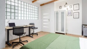 A room with a desk, two chairs, a green rug, a wardrobe, and a door with frosted glass panels. - House in Saint-Pabu near Stunning Beaches (Warszawa 2)
