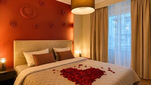 A hotel room with a bed, decorative wall panels, a large window with curtains, and a hanging light fixture. - Central Warsaw Home with Pool (Warszawa)