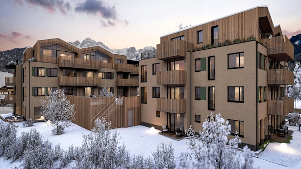 A multi-story building with balconies and large windows, surrounded by snow-covered trees and mountains in the background. - 3-bedroom Apartment With Sauna (Soell)