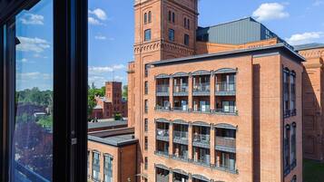 A multi-story building with a prominent tower and a flat-roofed section.