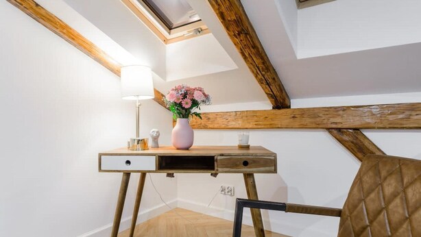 A room with a desk, chair, and a skylight. - Duplex Home near Manufaktura (Łódź)