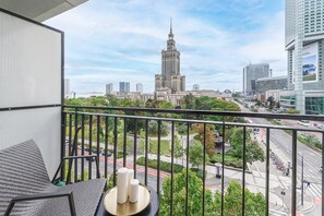 A balcony with a view of a cityscape, including a prominent building with a spire. - City View Apartment in Warsaw (Warszawa 2)