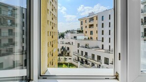 A view from a window of a multi-story residential building with balconies and a clear sky. - Apartment with Private Balcony (Warszawa 2)