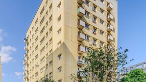 A high-rise residential building with multiple balconies and windows. - Apartment with Private Balcony (Warszawa 2)