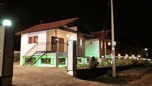 A two-story building with a balcony and a staircase. - MASBAH RESIDENCY (Mananthavady)
