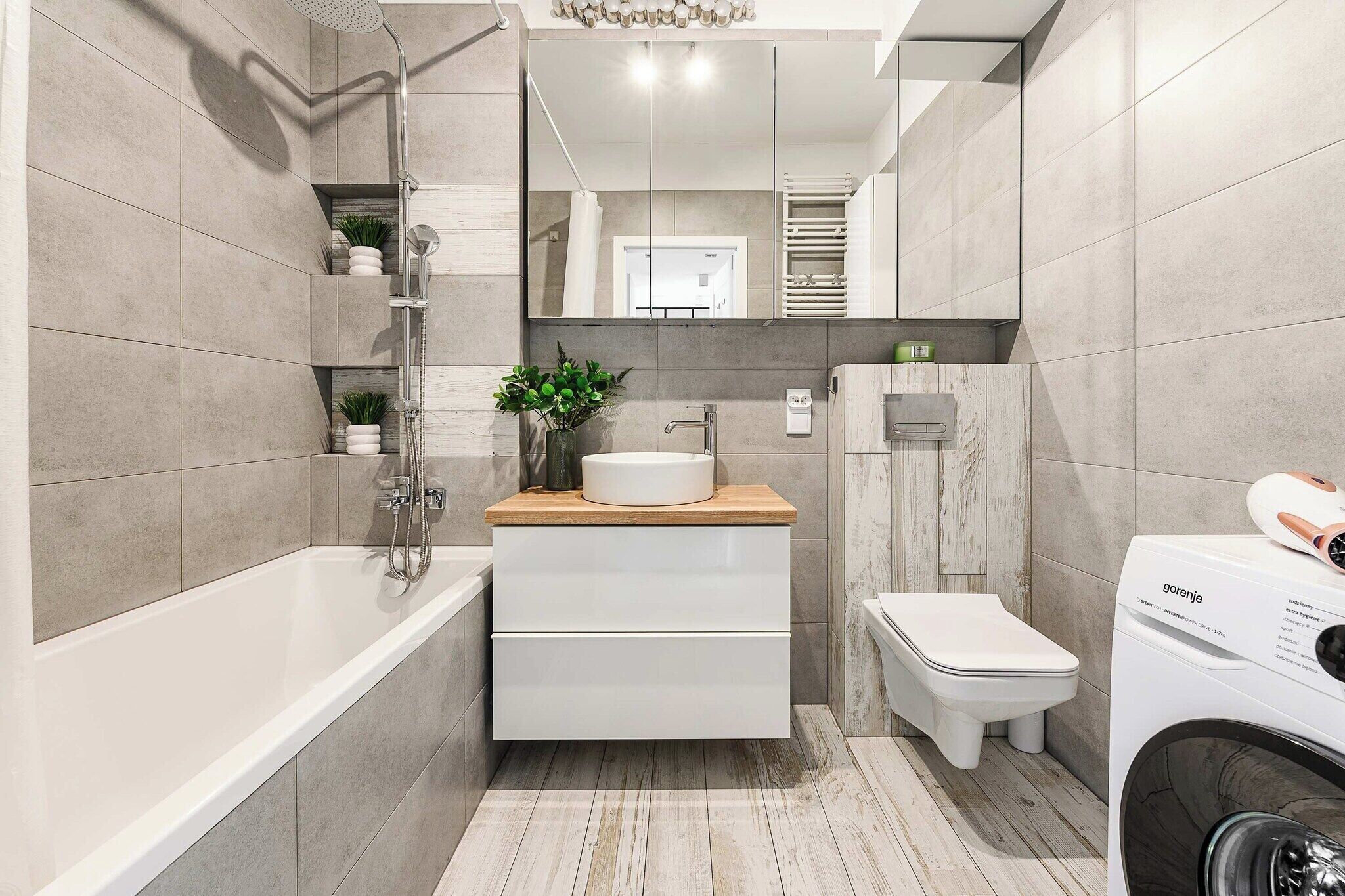 Un baño moderno con bañera, lavabo, inodoro y lavadora.