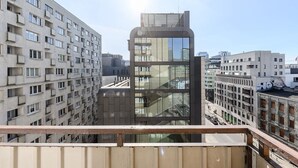 A high-rise building with a modern glass facade, surrounded by other residential buildings. - House in Porspoder by Plage du Bourg Beach (Warszawa 2)