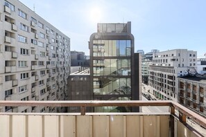 A high-rise building with a modern glass facade, surrounded by other residential buildings. - House in Porspoder by Plage du Bourg Beach (Warszawa 2)