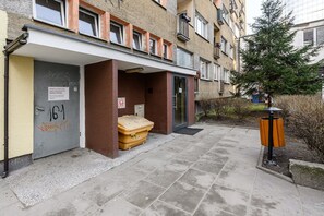 A building with a door marked '161' and a trash bin outside. - Central City Apartment with Balcony in Warsaw (Warszawa 2)