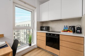 A modern kitchen with a built-in oven, microwave, and Bosch coffee maker. - House in France near Plage du Bourg Beach (Łódź)
