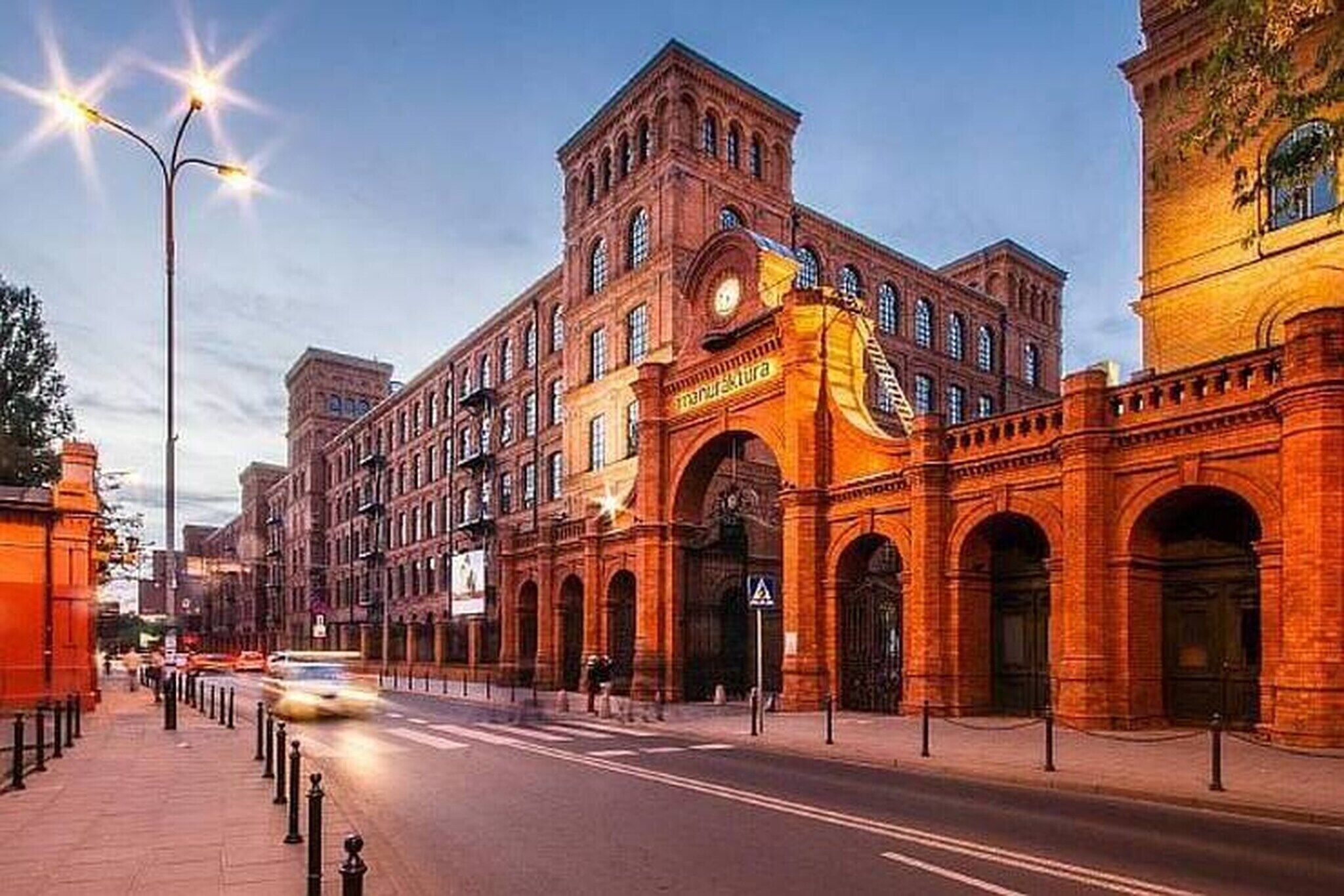 A historic building with arched entrances and a prominent clock tower.
