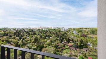 A residential area with a mix of houses and apartment buildings, a river, and a clear sky.