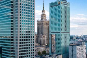 A cityscape with modern high-rise buildings and a historic tower. - Modern Apartment Stay Near Paris (Warszawa)