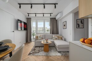 A modern living room with a sofa, coffee table, and a flat-screen TV displaying 'NETFLIX'. - House in Saint-Pabu near Stunning Beaches (Warszawa 2)