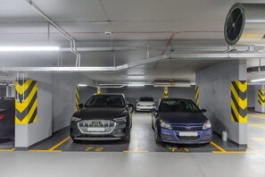 Eine Parkgarage mit zwei Autos, die in dafür vorgesehenen Stellplätzen mit den Nummern 72 und 73 geparkt sind.