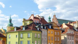 A row of colorful buildings with traditional architecture, including domed and spire-topped structures. - Comfortable house with splendid sea view (Warszawa)