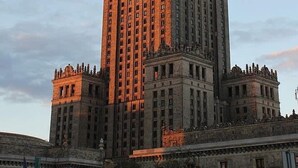 A large, multi-story building with a prominent central tower and symmetrical wings. - Comfortable house with splendid sea view (Warszawa)