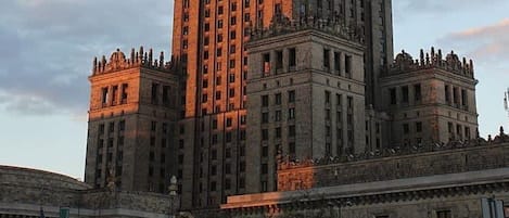 A large, multi-story building with a prominent central tower and symmetrical wings.