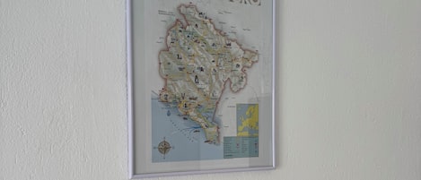 A framed map of Montenegro on a white wall.