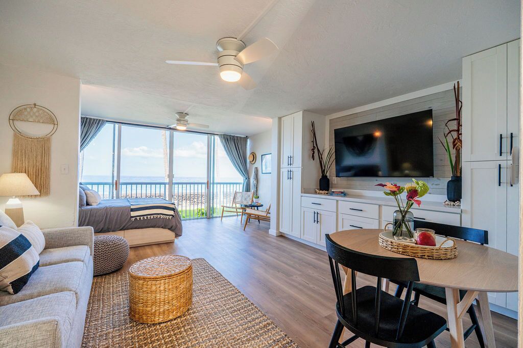 A modern interior with a balcony, a dining area, and a living space.