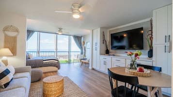 A modern interior with a balcony, a dining area, and a living space.