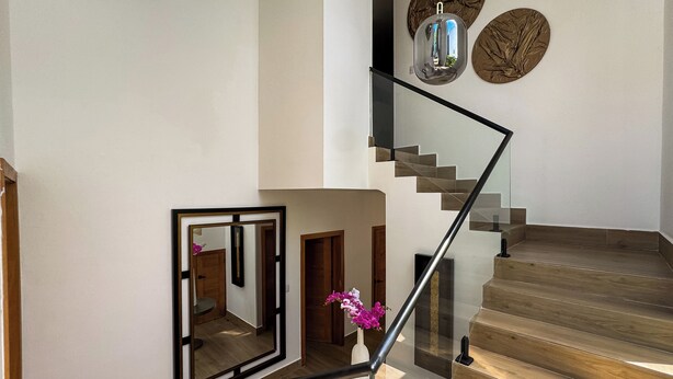 Eine moderne Treppe mit Glastrennlärm und Holzbodenstufen.