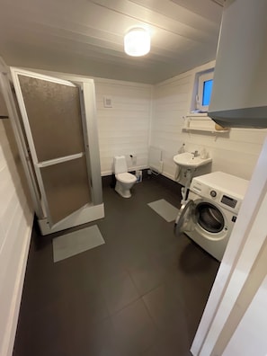 Un baño pequeño con inodoro, lavabo y lavadora.