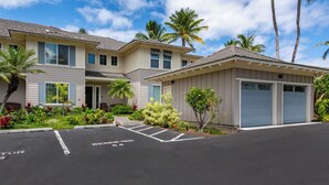 A residential building with a garage, a driveway, and a parking space marked 'RESERVED 54'. - Hilton Pool Pass for 2026!  Lake Views.  M2 Waikoloa Fairway Villas (Waikoloa Beach Resort)