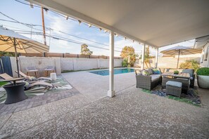 A covered outdoor area with a pool, seating, and a pergola. - The Ultimate Scottsdale Hangout - 3 Bedroom Sleeps 10 (Scottsdale)