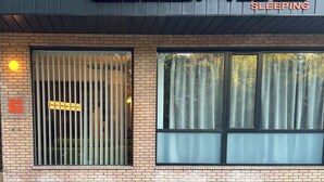 A building with a sign reading 'CABINS SLEEPING' and a barred window.
