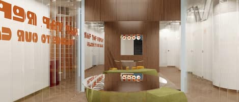 A modern interior with a curved seating area, wooden panel walls, and a glass partition with orange text.