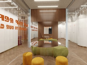 A modern interior with a curved seating area, wooden panel walls, and a glass partition with orange text.