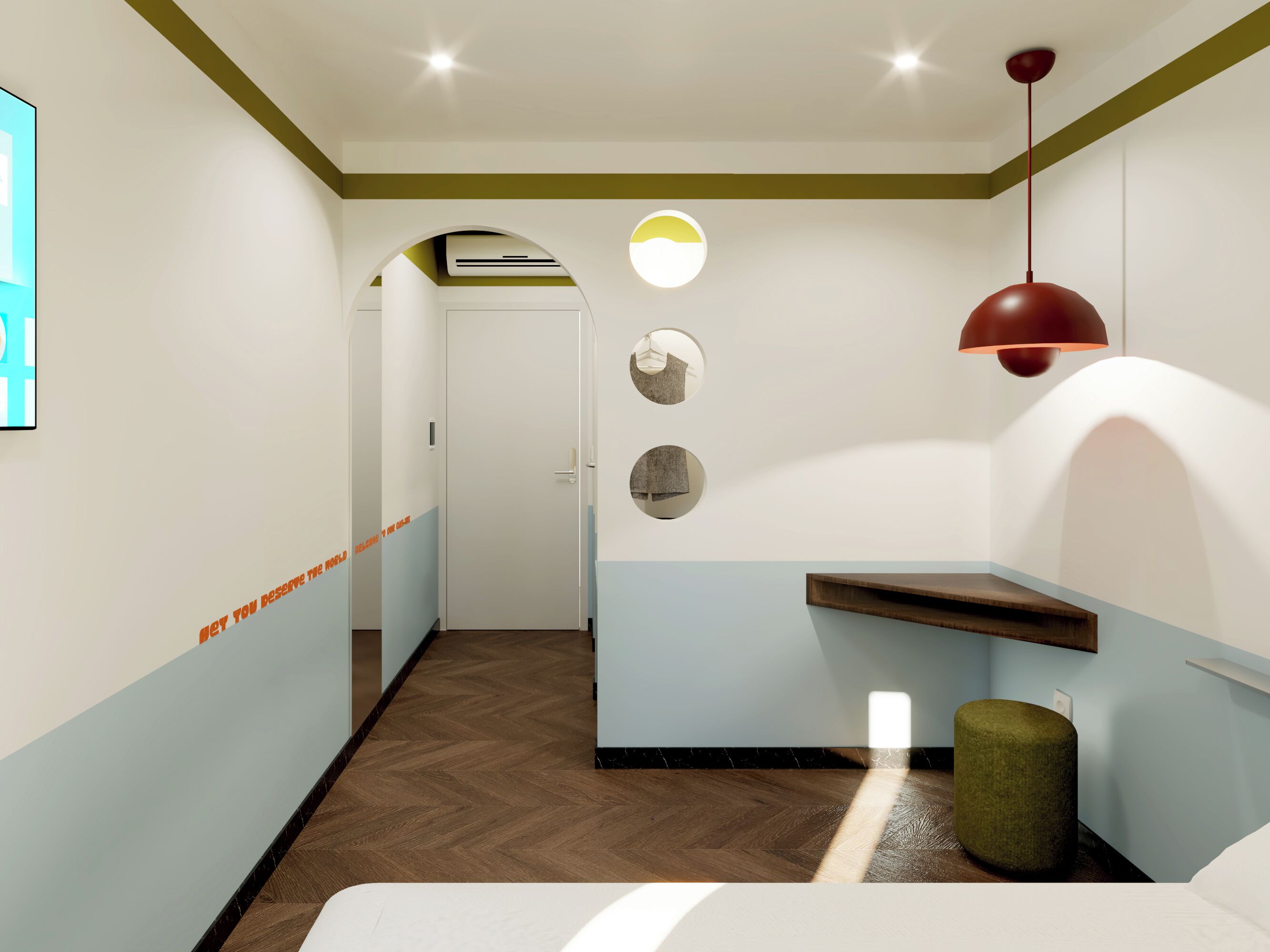 A hotel room with a bed, a small seating area, a wall-mounted shelf, and a hallway leading to another room.