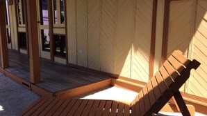 A wooden deck with a single lounge chair. - Villas de la Bahía Playa Tambor (Cobano)