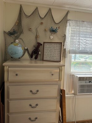 A room with a dresser, a globe, a lobster, and a framed inspirational quote. - 3 bedroom Beach House central to food and shops, steps away from the ocean. (Old Lyme)