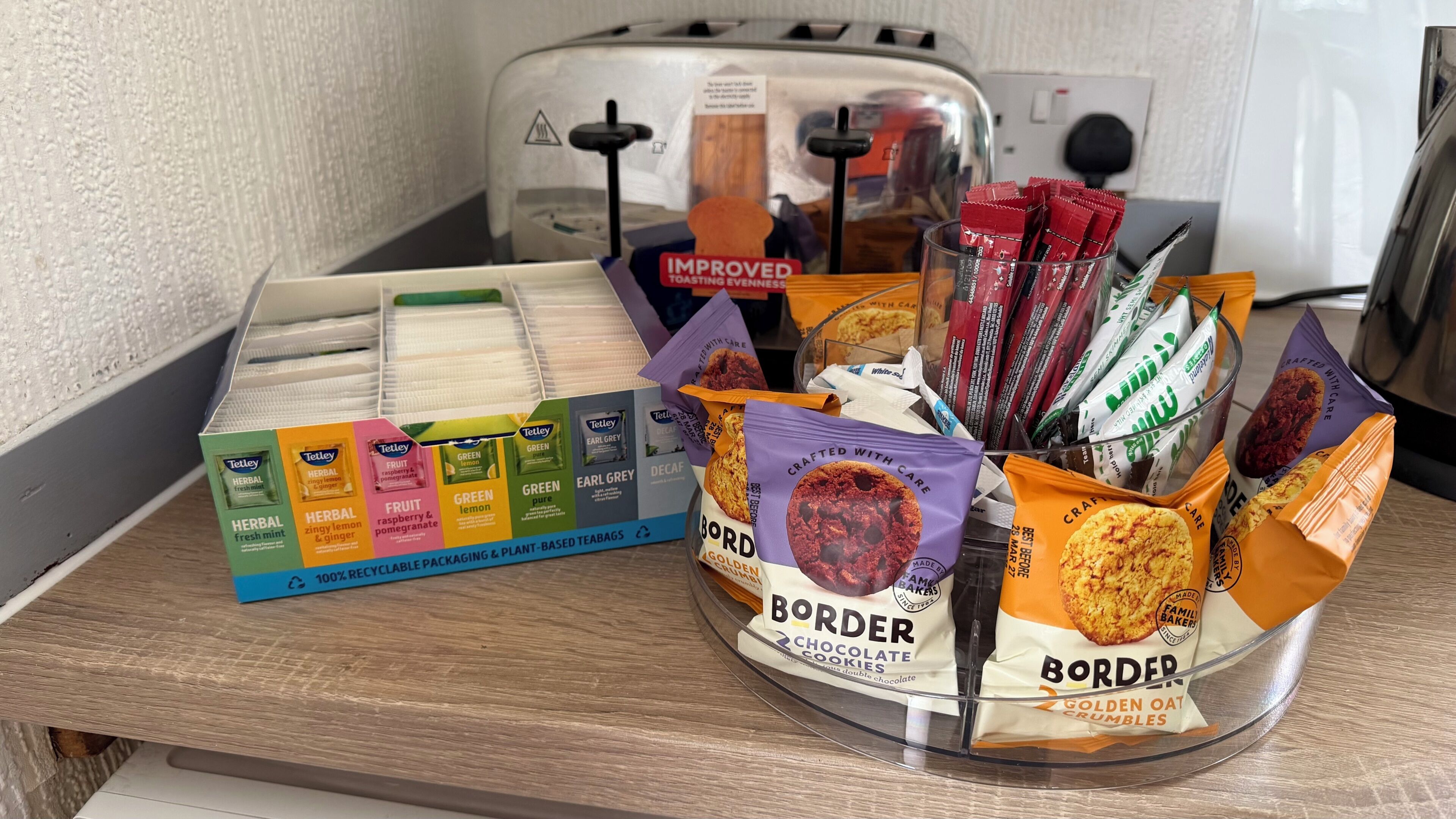 A kitchen counter with various packaged food items, including tea bags and cookies.