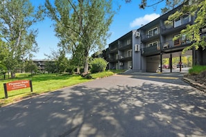 A multi-story residential building with balconies and a sign indicating 'Pioneer Park Condos.' - Cozy Condo by Downtown (Bend)