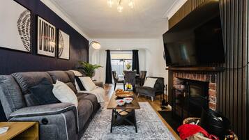 Una sala de estar moderna con sofá, mesa de centro y chimenea.