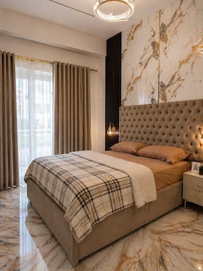 A modern bedroom with a large bed, marble flooring, and a decorative wall.