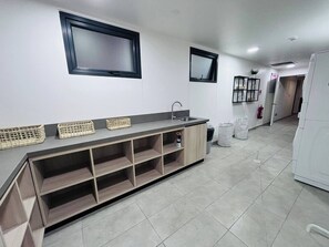 A modern kitchen with a built-in island, a sink, and a refrigerator. - Apartment, 2BR/2BA, AC and Heating, parking y GYM. (Ñuñoa)