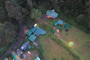 An aerial view of a property with multiple buildings, a road, and a swimming pool. - Eagle woods Resort (Kodaikanal)