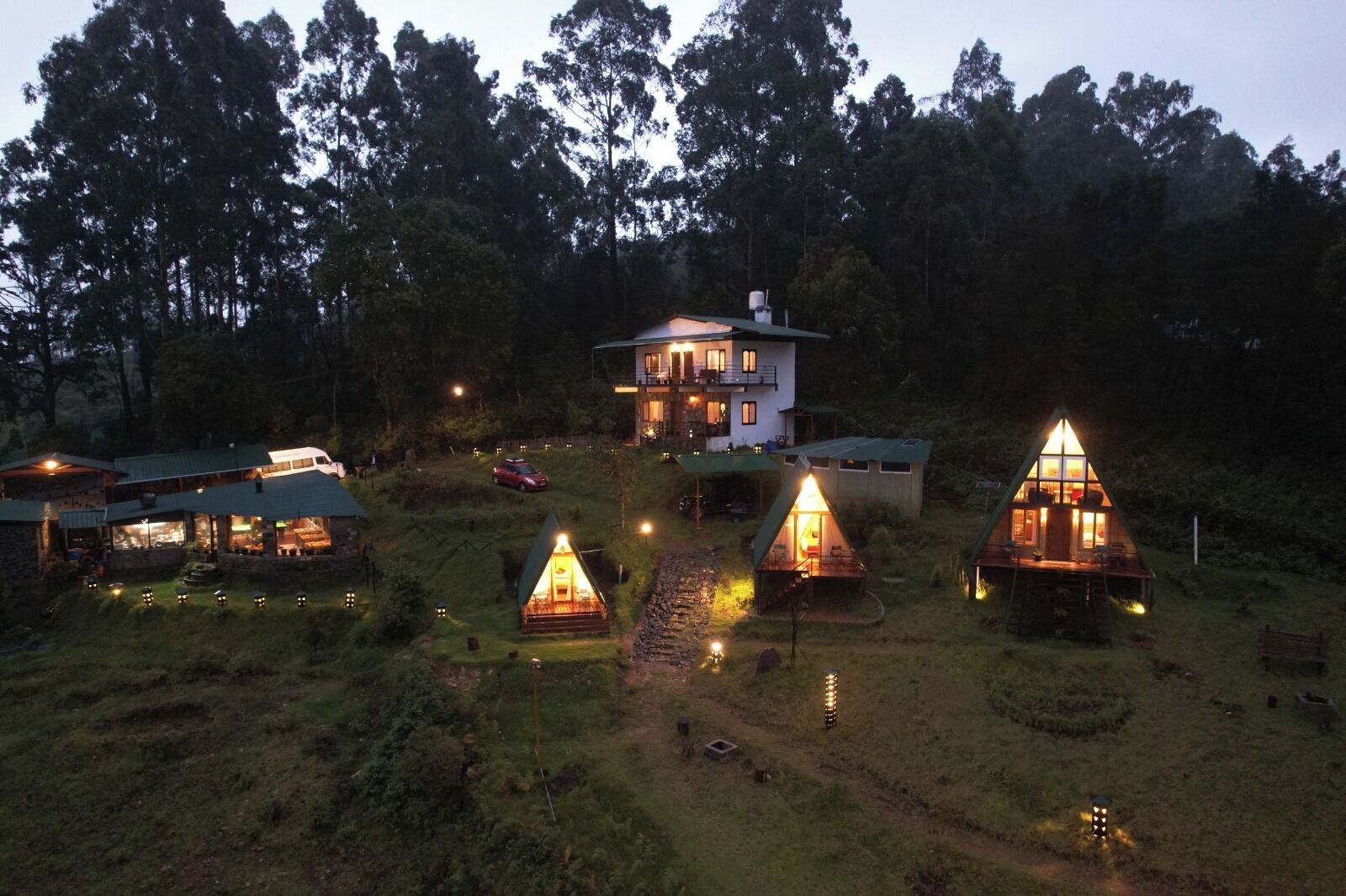 A lodge with multiple cabins, a main building, and a forested backdrop.