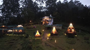 A lodge with multiple cabins, a main building, and a forested backdrop.