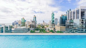 A modern cityscape with high-rise buildings and a swimming pool in the foreground. - w* | Upscale 1BR in Obarrio w/ AC (Panamá)