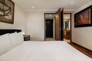 A hotel room with a large bed, a nightstand, a dresser, and a painting on the wall. - w* | Luxury 1BR in Polanco (Ciudad de México)