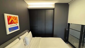 A hotel room with a bed, a painting, a wardrobe, and a window with a view. - w* | Sunlit Loft w/ Private Terrace in Tabacalera (Ciudad de México)