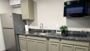 A kitchen with a refrigerator, microwave, sink, and cabinets. - Cozy 1-bedroom apartment in marvelous Odessa with AC (Odessa)