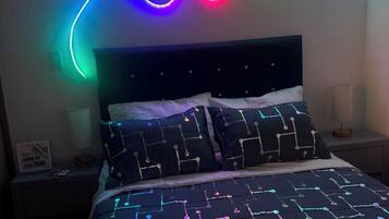A bed with a black headboard and a patterned bedspread.